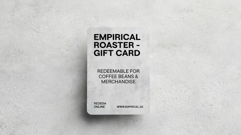 Empirical Roaster gift card standing upright on a concrete surface