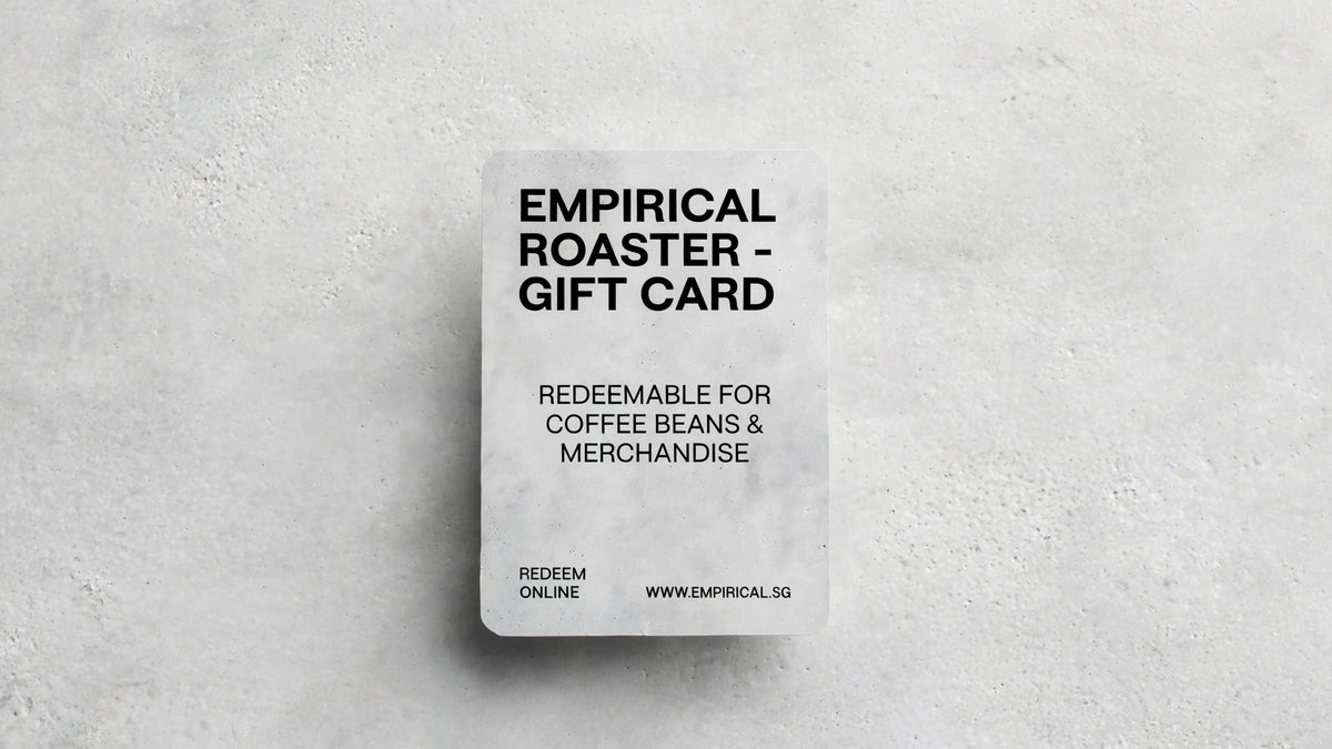 Empirical Roaster gift card standing upright on a concrete surface