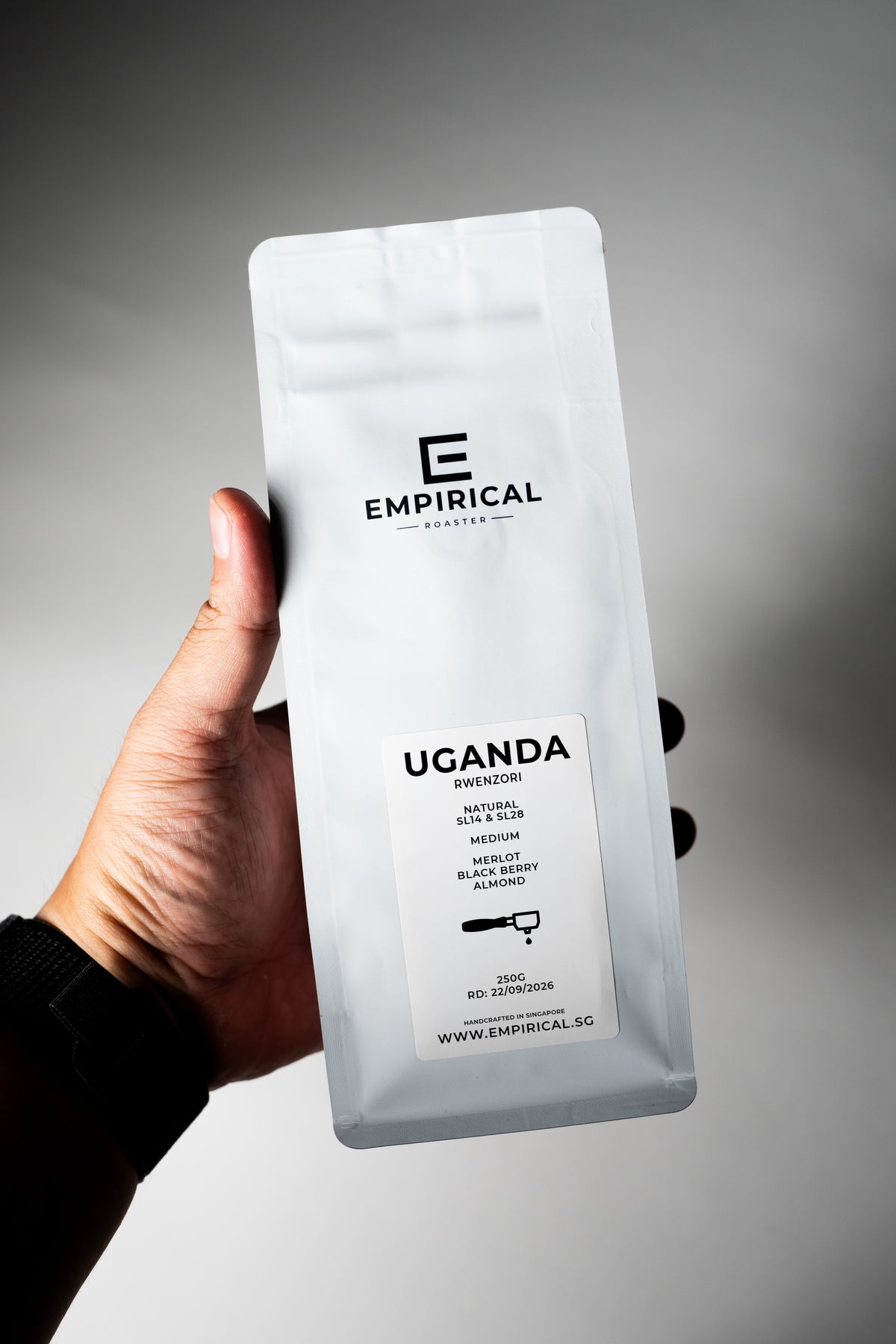 Empirical Uganda Rwenzori coffee bag held in hand